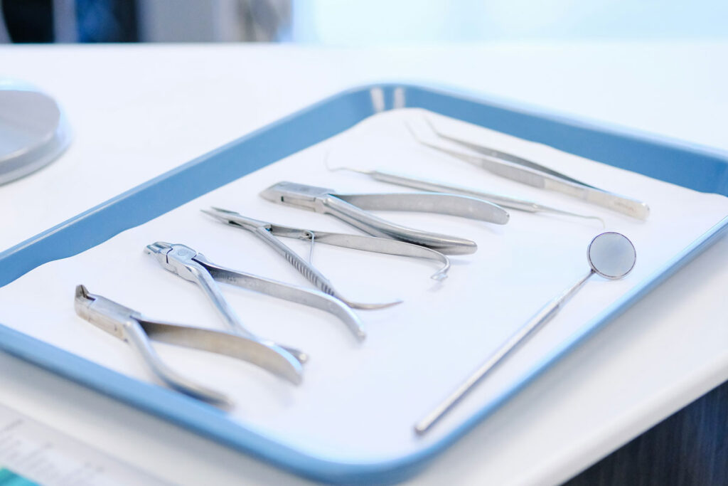 Dental instruments laid out on sterilized tray for procedure